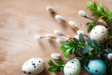 Easter decoration with easter eggs, catkins and boxwood twigs on wooden background