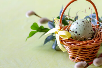Basket with easter egg, catkins and boxwood. Easter decoration concept