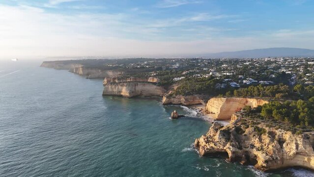 Aerial view of the Algarve coastline with high cliffs at sunset, Portugal