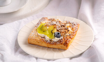 Morning breakfast with buns with cream, berries, fruits on a white tray. Breakfast in bed.