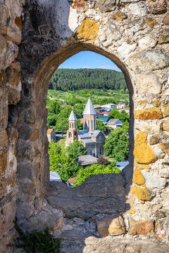 Church of Saint George in Surami, Georgia, seen through stone window frame in medieval Surami fortress.