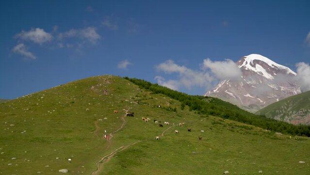 View of the peak of Kazbek looking out from behind the mountains on a clear day