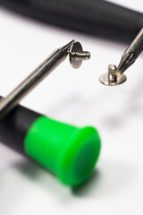 Magnetic screwdrivers with screws on a white surface, isolated
