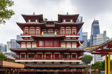 Buddha Tooth Relic Temple in Chinatown, Singapore, with Singapore`s business district in the background.