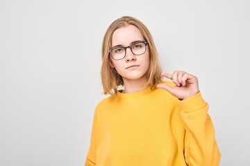 Portrait of girl showing fingers small size, just a little