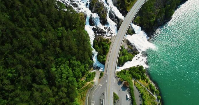 Aerial panning view, waterfall flowing down mountain side. Tourism in Iceland. Inspiration in nature. Langfoss waterfall