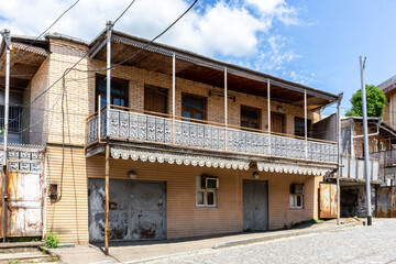 Traditional residential two-storey house in Kutaisi with lathed openwork ornamental balcony.