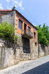 Traditional residential two-storey building in Kutaisi with lathed openwork ornamental balcony and...