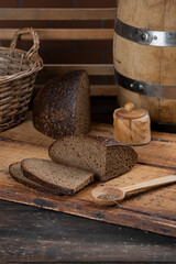Dark rye bread sliced on a wooden table. Country style.