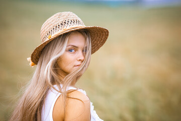 Portrait Happy Girl in a Wheat Field - 745237240