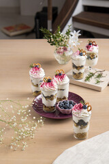 Dessert with blueberries and whipped cream in flower cut cups