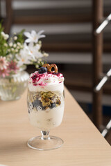 Dessert with blueberries and whipped cream in flower cut cups