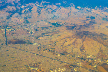 Flying airplane over Mexico Clouds Sky Volcanoes Mountains City desert.