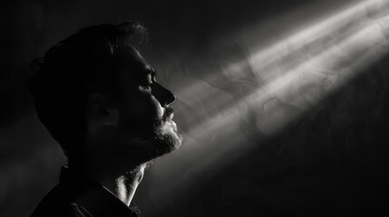 A thinker in shadow, with a single beam of light illuminating their face, focusing on the moment of insight and clarity