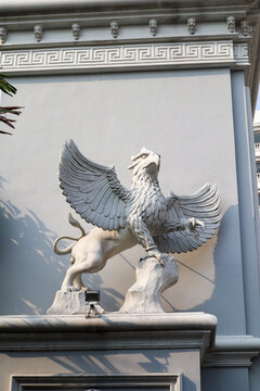 a gryphon statue with white paint. mythology creature. surabaya, indonesia - 21 february 2024