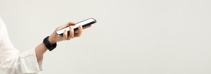 Close-up of a hand holding a smartphone with a white screen, featuring a woman in a white blouse