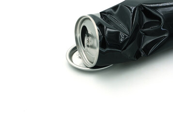 Black cans and caps of soda cans on white background, recycled material concept.