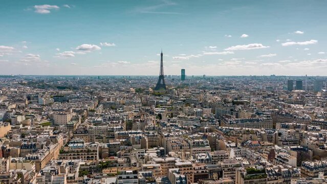 PARIS, FRANCE - FEBRUARY 20, 2024 : Aerial drone timelapse motion hyperlapse view of the Eiffel Tower and Champ de Mars, famous touristic landmark.