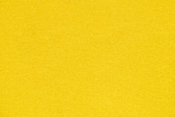 Close-up of vibrant yellow textured cardstock.