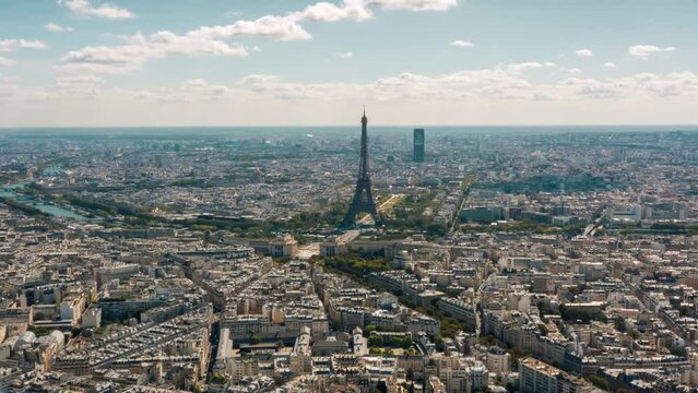PARIS, FRANCE - FEBRUARY 20, 2024: Aerial drone timelapse motion hyperlapse view of the Arc de Triomphe (Triumphal Arch of the Star) with traffic on circle road. Famous monument from above.
