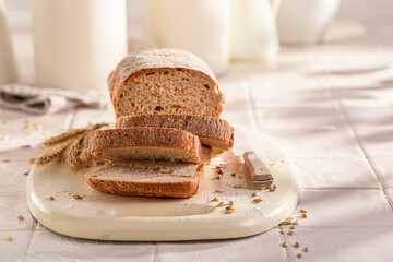 Rectangular loaf of rye bread baked in home bakery.
