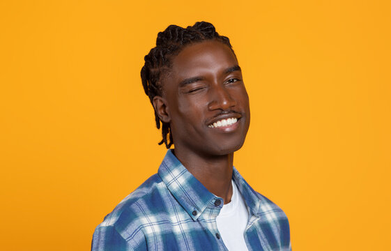 Confident handsome young blank man winking and smiling at camera