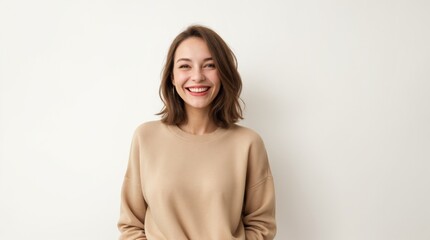 Fototapeta premium Lady in beige jumper radiating happiness against white backdrop