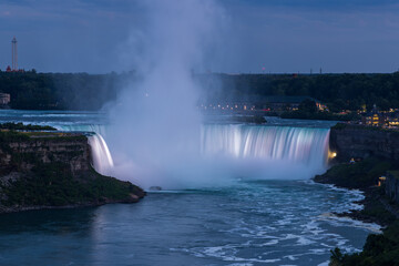 Elevated view of brightly illuminated Horseshoe falls at dusk, Niagara Falls, Canada