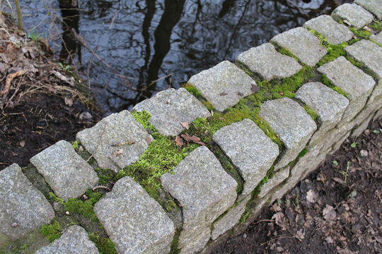 A stone bridge covered with moss