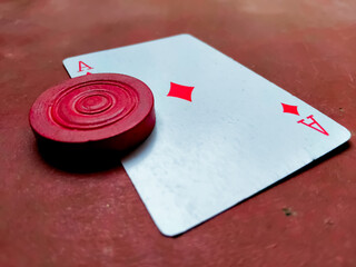 Playing card (ace) with the carrom piece, casino - obrazy, fototapety, plakaty