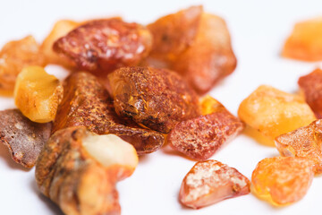 Bright raw Baltic amber on white background.