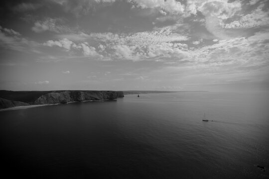 high angle black and white picture of a sailship at the coast of Portugal 