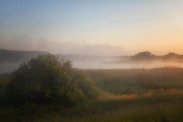 Beautiful summer landscape with the fog lit with a sunrise - 745288827