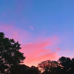 Fototapeta na wymiar Sunset sky graient vibrant pinks an oranges tranquil evening