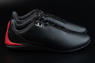 Pair of black leather motorsport shoes