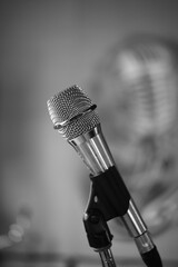 Black and white photo. Podcast audio vocal mic Broadcasting studio. Closeup on a professional microphone studio background. Tracking shot of microphone 4 K slow motion