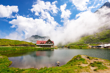 balea lake of romania in summer. sunny weather with stunning clouds on the blue sky. alpine landscape of fagaras mountains