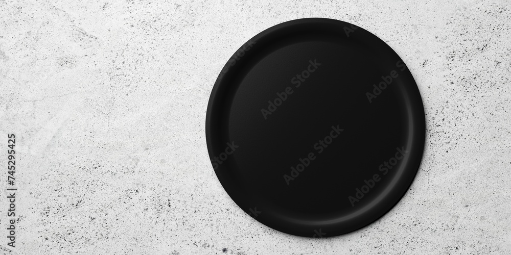 Poster single empty black ceramic plate on concrete table background with copy space, flat lay top view fro