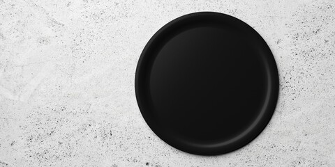Single empty black ceramic plate on concrete table background with copy space, flat lay top view from above - obrazy, fototapety, plakaty