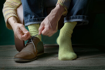 Tying laces on shoes. Men's socks. Men's socks on feet. Silk socks.