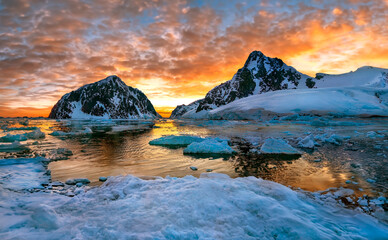Midnight Sun and the entrance to the Lamaire Channel on the Antarctic Peninsula in Antarctica.