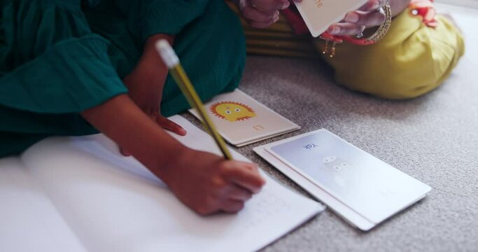 Mom, child and hands writing for home school education, English language or literacy development on floor with flashcard. Indian family, parent or girl for learning words, alphabet letter or teaching