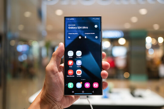 PENANG, MALAYSIA - Feb 13, 2024: Hand holding Samsung Galaxy S24 Ultra 5G in Samsung store. Samsung Galaxy Ai. Samsung 2024 Flagship phone..