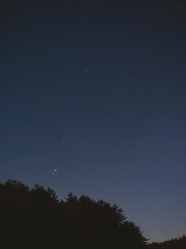 A time-lapse of the Orion Constellation moving through the night sky. Orion's Belt, the Orion Nebula, and the star Betelgeuse are all visible. Many stars are visible in the night sky.