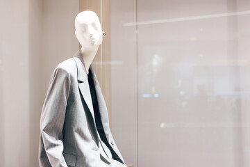 Female mannequin in gray jacket close up