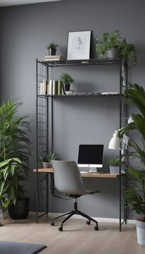 Dark open space living room interior with metal rack, grey armchair and plants in the background and study corner hairpin desk, books and empty monitor in the foreground 
