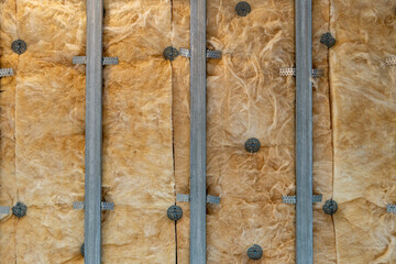 Metal ceiling framework with soundproofing, fixed to concrete using anchors, showcases assembly technology for acoustically insulated spaces.