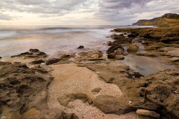 rocks on the beach at sunset, Coast of Argentiera near La Frana. SS, Sardinia, Italy