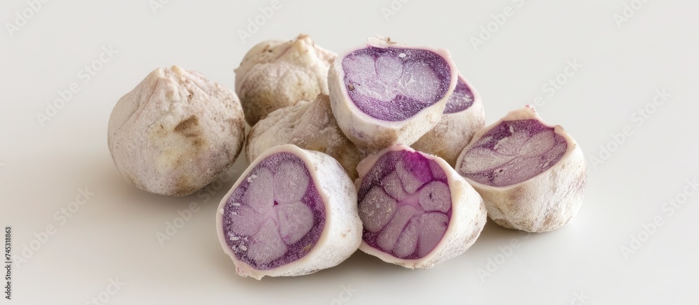 Poster A close-up view of a cluster of purple fruits, showcasing their vibrant color and unique shapes. The fruits are ripe and ready to be enjoyed, adding a pop of color to any setting.