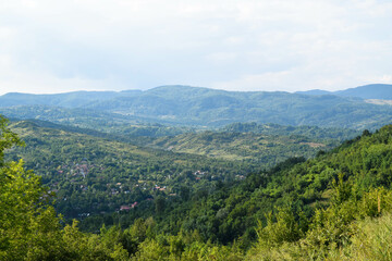Fototapeta na wymiar Spring mountain view of city village from Romania Carpathians top of mountain